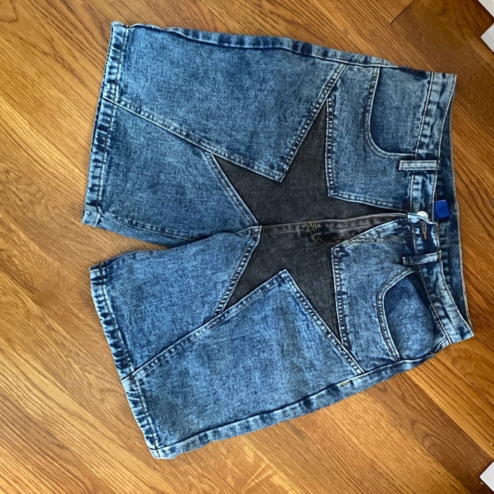 Dark blue Jean Shorts with a star printed in the middle.